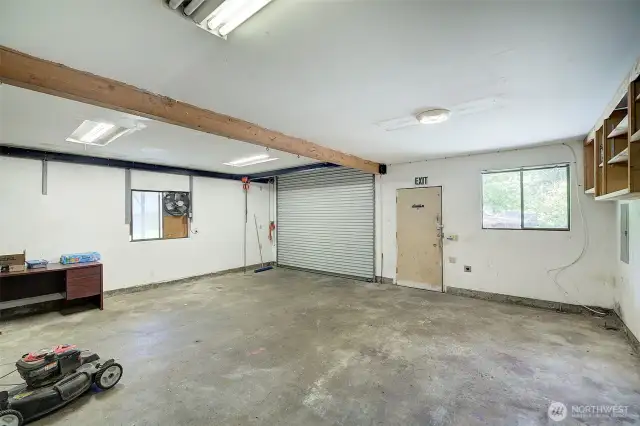 Interior of the multi car shop/garage.  A heavy duty roll-up garage is featured here.