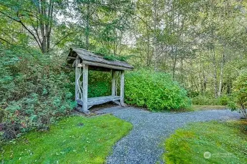 Private covered bench area overlooking pond