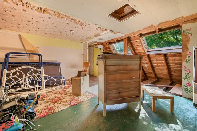unfinished portion upstairs; church bell visible through attic access in ceiling