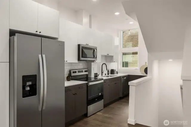 New stainless steel appliances and quartz countertops
