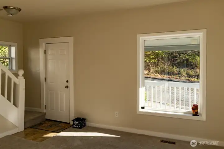 Entry and stairs up. 2 large windows in living room