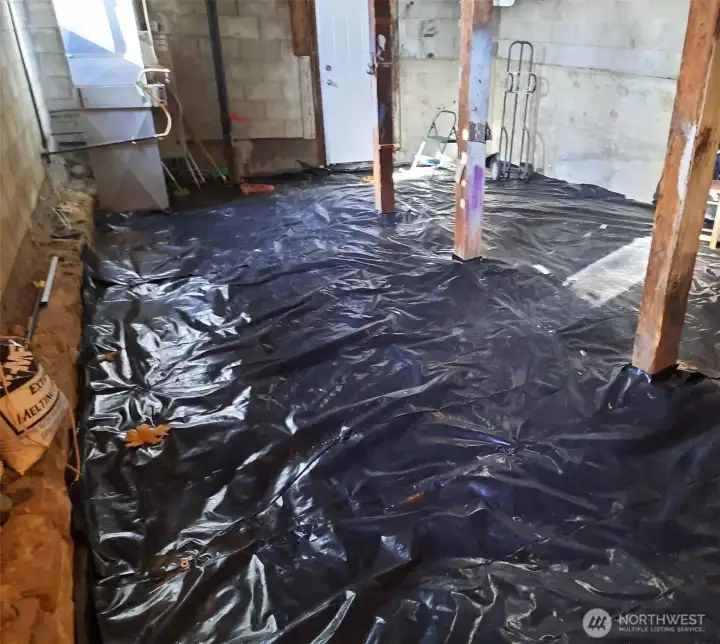 New vapor barrier in crawl space with 9 foot ceilings.