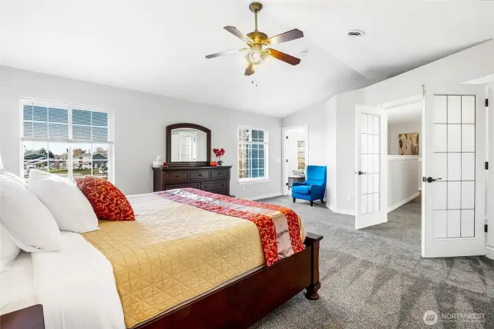 Walk through the french doors into your upstairs primary bedroom. View of the lake from the window.