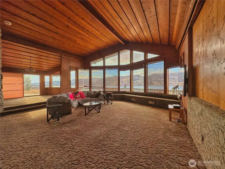 Living room to dining room view and a gorgeous etched artisan sliding interior wall panel opens to home office