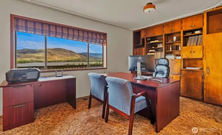 Large home office on upper level with sliding interior wall panel that opens to living room