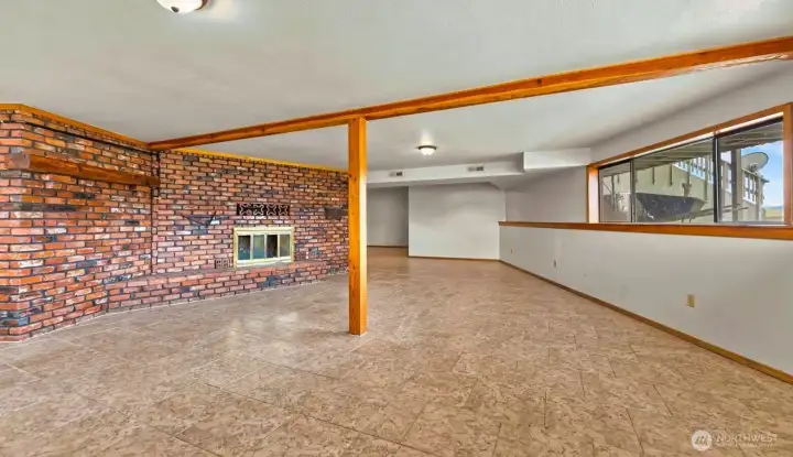 Family room with brick fireplace wall feature