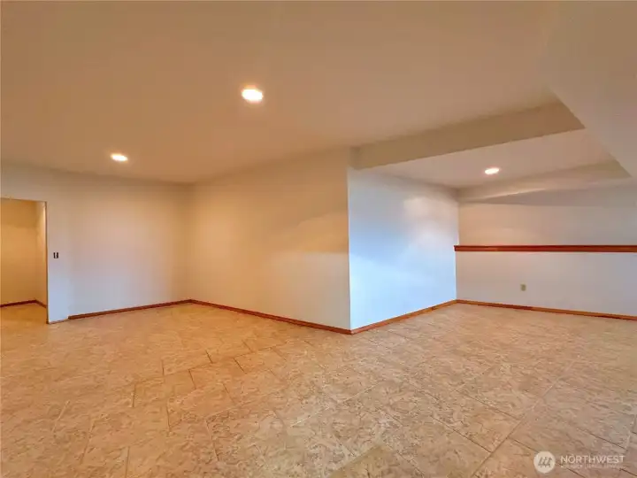 Recreation room space in daylight basement with recessed can lighting