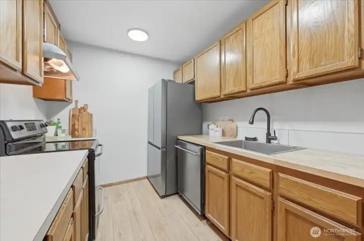 Kitchen with new sink, faucet, disposal, and appliances