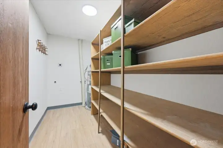 Laundry area with extra storage near entry door