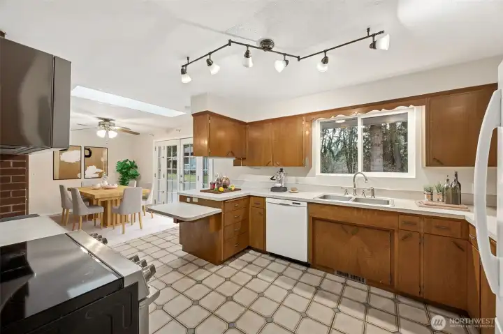 A welcoming kitchen layout with great prep and storage space. Range with induction stove & newer microwave