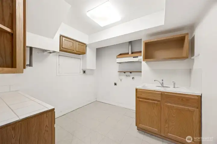 Lower-level | 2nd Kitchen area with sink, hood, cabinets and counters.