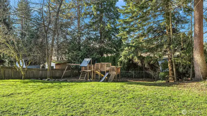 Huge fully-fenced backyard with playset and plenty of room for imagination!