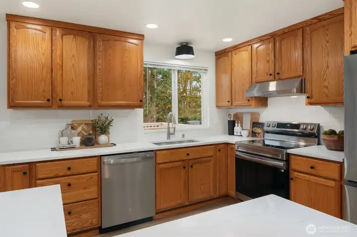 Kitchen opens to living, dining, and upper deck for easy sight lines.