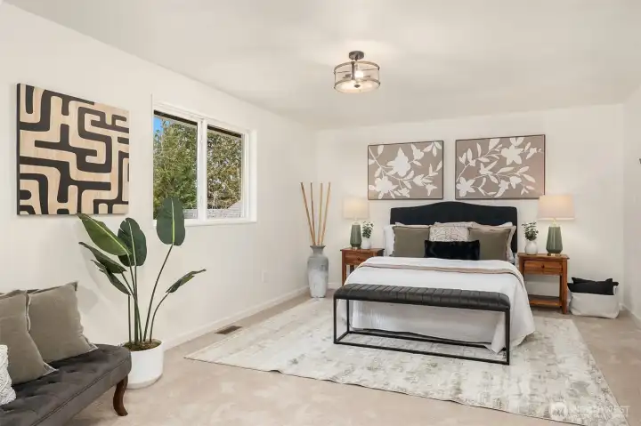 Spacious primary suite easily accommodates a king-size bed and sitting area.