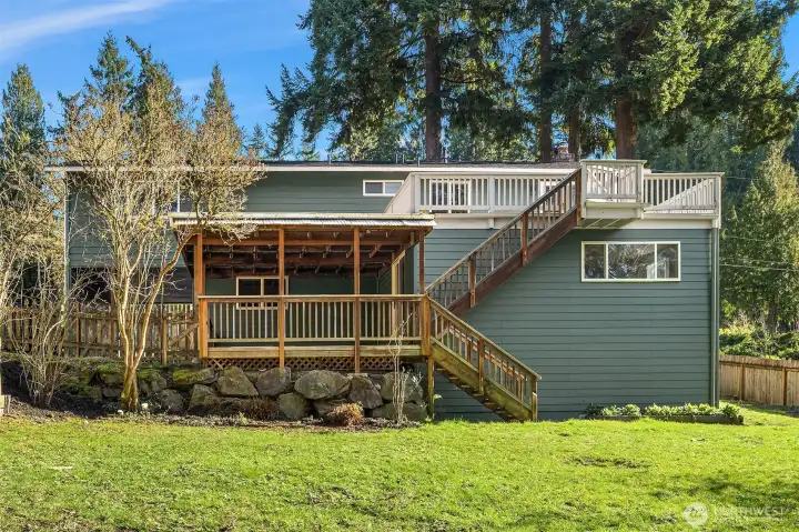 Exterior back with garden beds on the right.