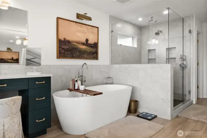 Accent vanity for makeup and getting ready. Beautiful free-standing tub with tile surround and grogeous oversized walk-in shower with dual shower heads.