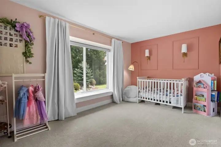 Bedroom 1 upstairs features a picture frame moulding wall accent and sconces.