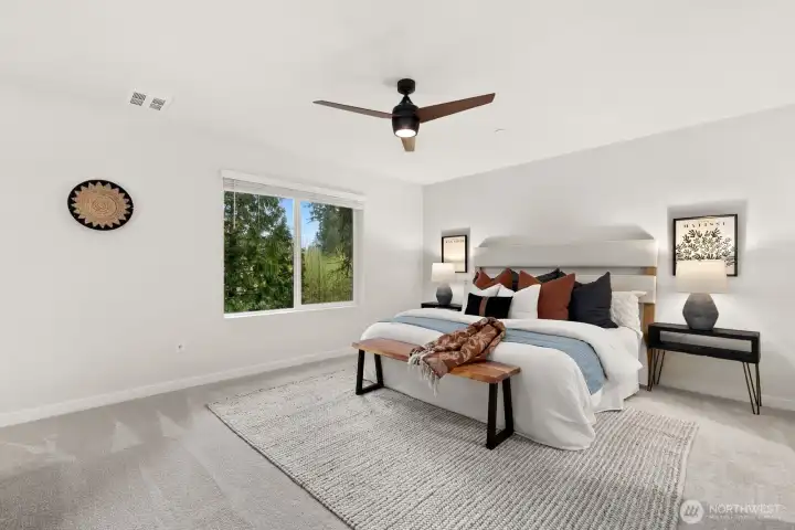 Oversized primary suite sits on upper level at back of unit and enjoys private and peaceful views of greenspace.