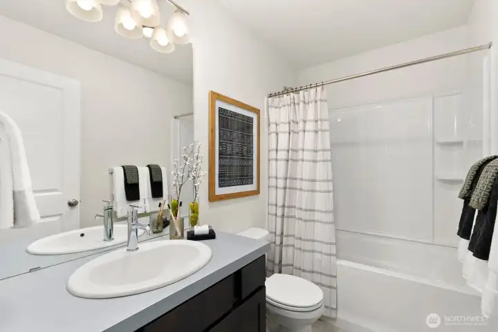 Upper level full bath sits just outside upper level bedroom - allowing each bedroom its own bath!