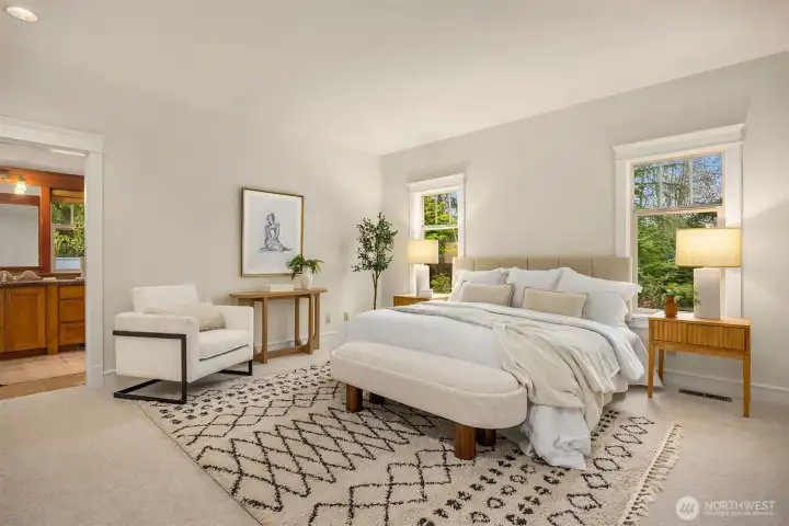 A spacious main-level primary suite offering comfort and convenience, complete with a private en-suite bath and a generous walk-in closet