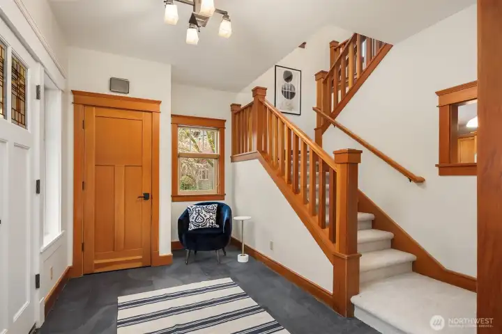 Just inside the front door, a stone entry sets the tone, served by a coat closet and a staircase leading to the upper level.