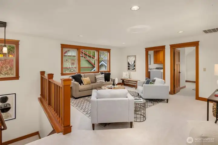 At the top of the stairs, a comfortable family room provides a central gathering space—perfect for relaxing, studying, or movie nights. From this hub, three upper-level bedrooms branch off, along with a full bath and laundry room. This creates a practical layout for everyday living.