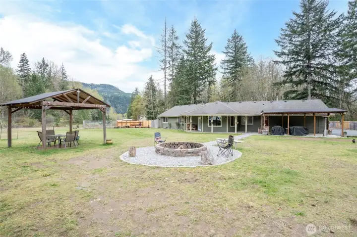 Covered gazebo offers additional outdoor entertaining space, perfect for relaxing around the firepit.