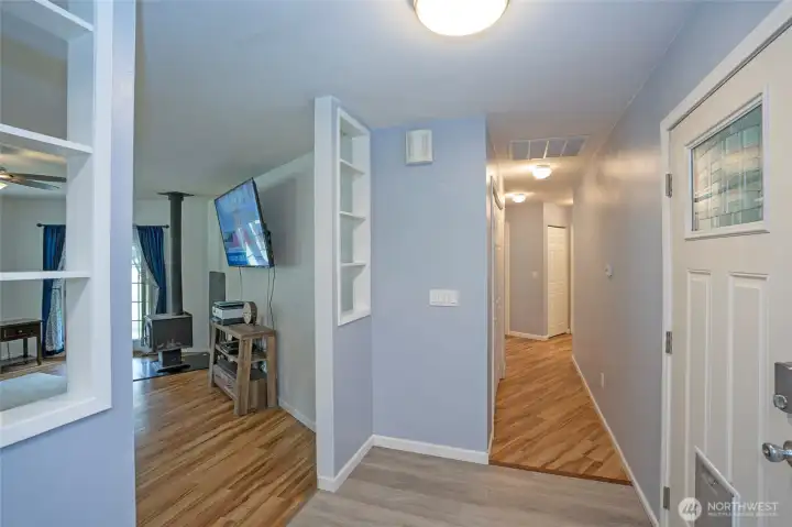 Front entry opens to a hallway providing access to the bedrooms, with the living area situated just to the left.