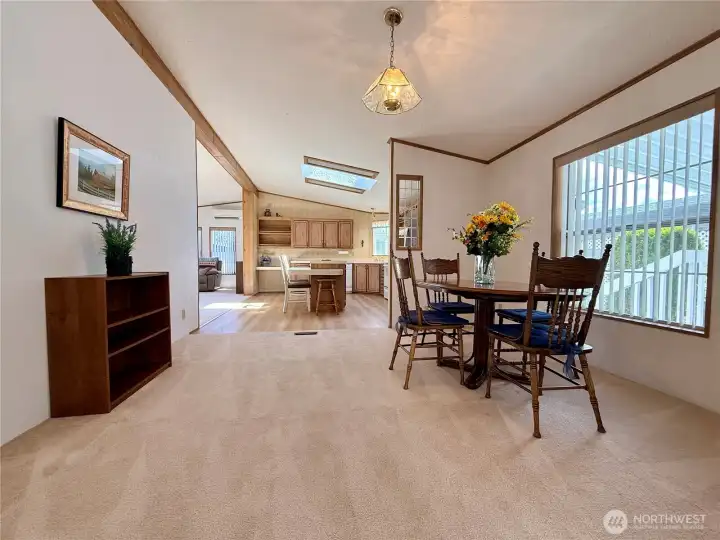 A view of the dining area, and kitchen and family room.