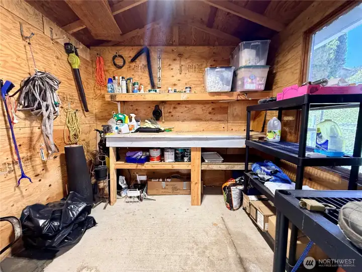 Storage unit behind carport.