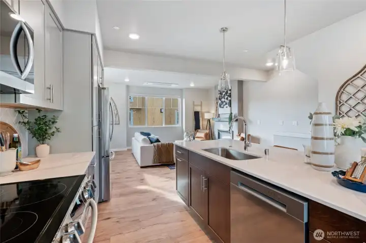Kitchen is finished with quartz counter tops, full height designer tile back splash and energy efficient LG Appliance packages.    Photos are of model home in the community.