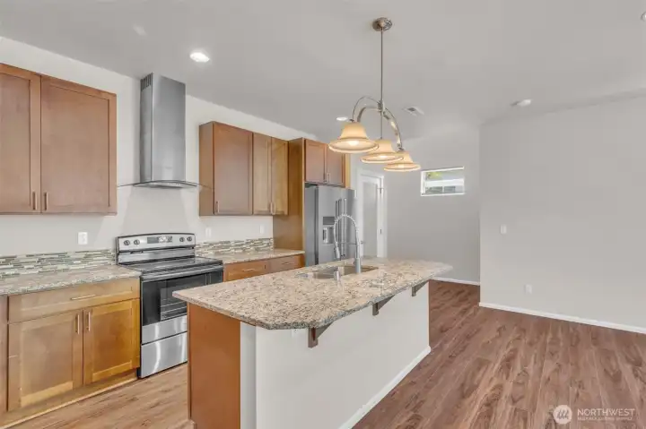 Open kitchen with a center island, lots of cabinet space, and granite counters plus most appliances are new.