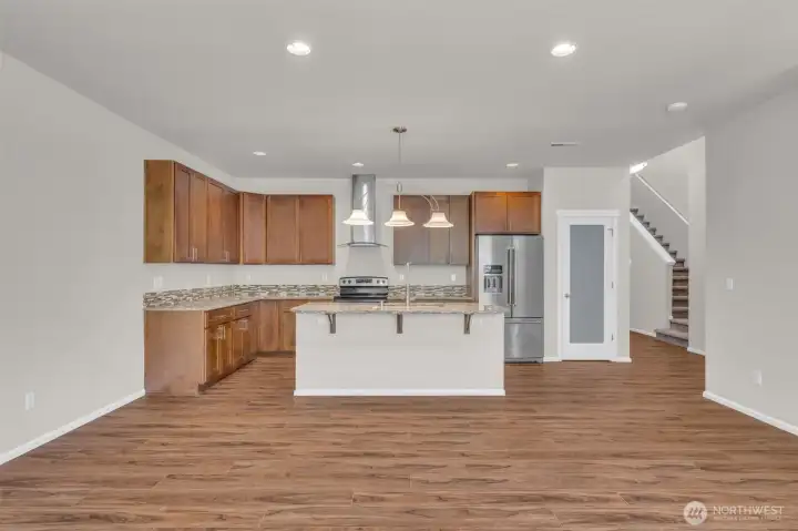 Another view of the kitchen with stainless steel hood