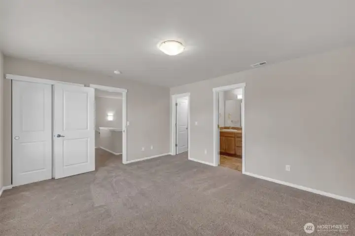 The primary bedroom has a walk-in closet, a full bath, and lots of room.