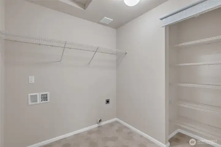 Large laundry room with storage on the 2nd floor.