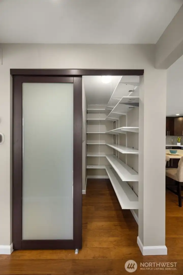 Spacious pantry next to kitchen and dining.