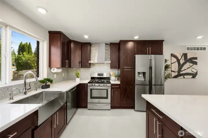 Remodeled kitchen with quartz countertops and backsplash, stainless steel appliances, double oven and eating nook