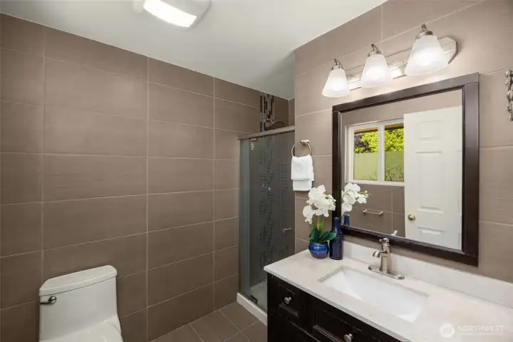 Master bathroom with floor to ceiling tiles