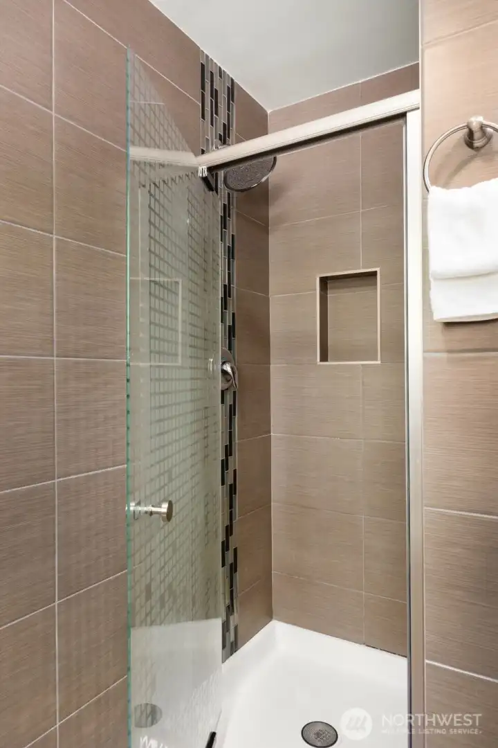 Master shower with floor to ceiling tiles