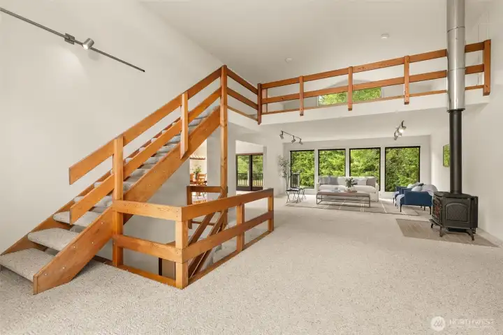 Great room with loft, propane free standing stove with territorial and river views. Great room with loft, propane free standing stove with territorial and river views.
