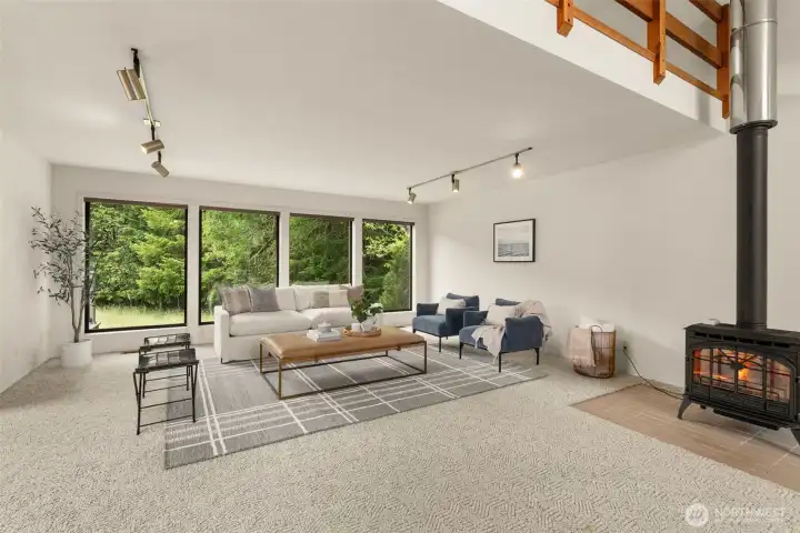 Great room with loft, propane free standing stove with territorial and river views. Great room with loft, propane free standing stove with territorial and river views.