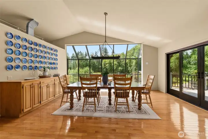 Dining room with large sliding doors that open to a spacious deck over looking the territorial and river views. Dining room with large sliding doors that open to a spacious deck over looking the territorial and river views.