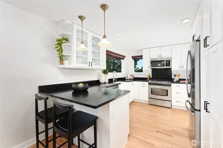 Kitchen has soapstone counters with professional appliances.