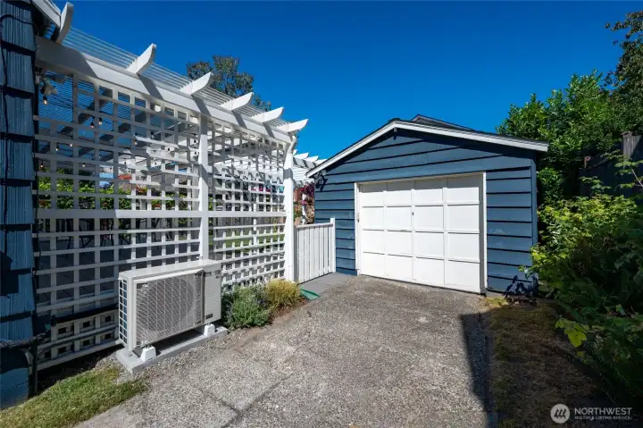 Detached 1-car garage with driveway with EV charger.