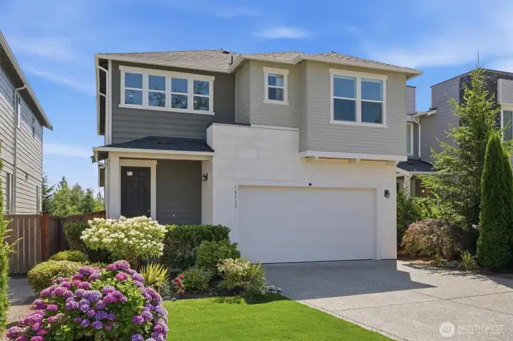 Welcome home! Beautiful curb appeal with manicured landscaping and inviting front entry.