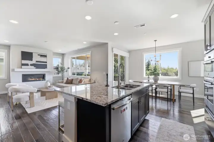 Open layout seamlessly connects the kitchen, dining, and living spaces.