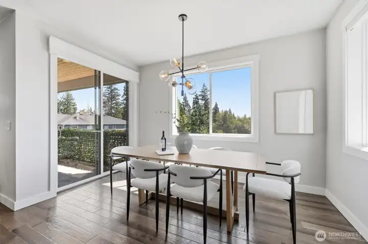 Sunny dining area with backyard views.