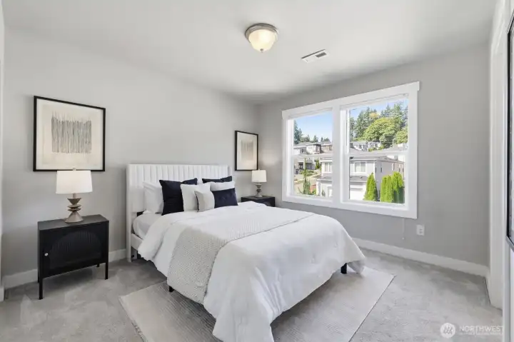 Spacious bedroom filled with natural light.
