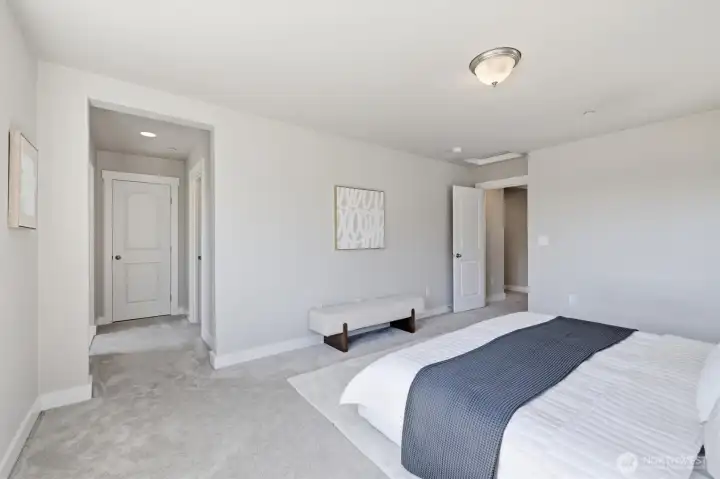 Spacious primary bedroom with neutral finishes.