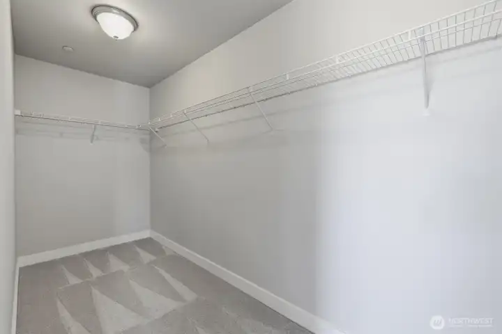 Expansive walk-in closet with built-in shelving.